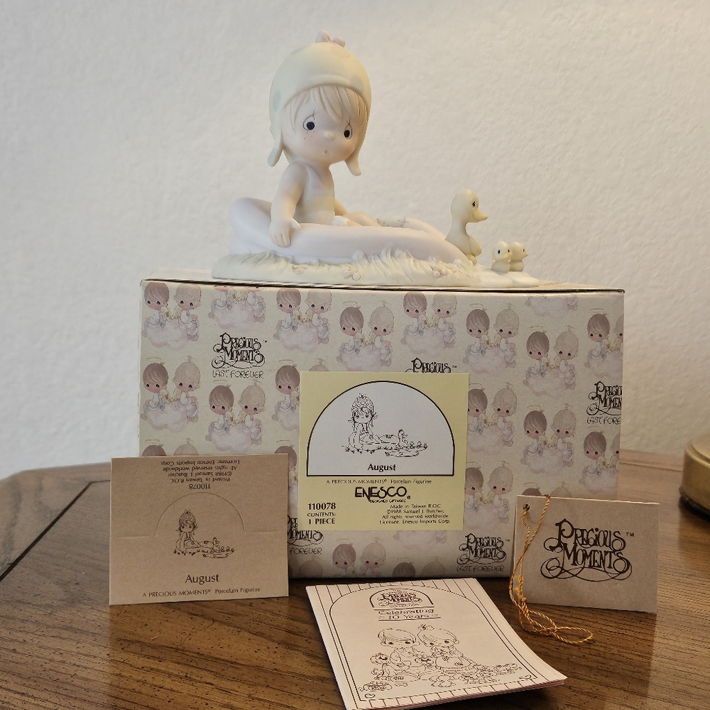 The Precious Moments "August" from 1988. New in the original packaging with tags